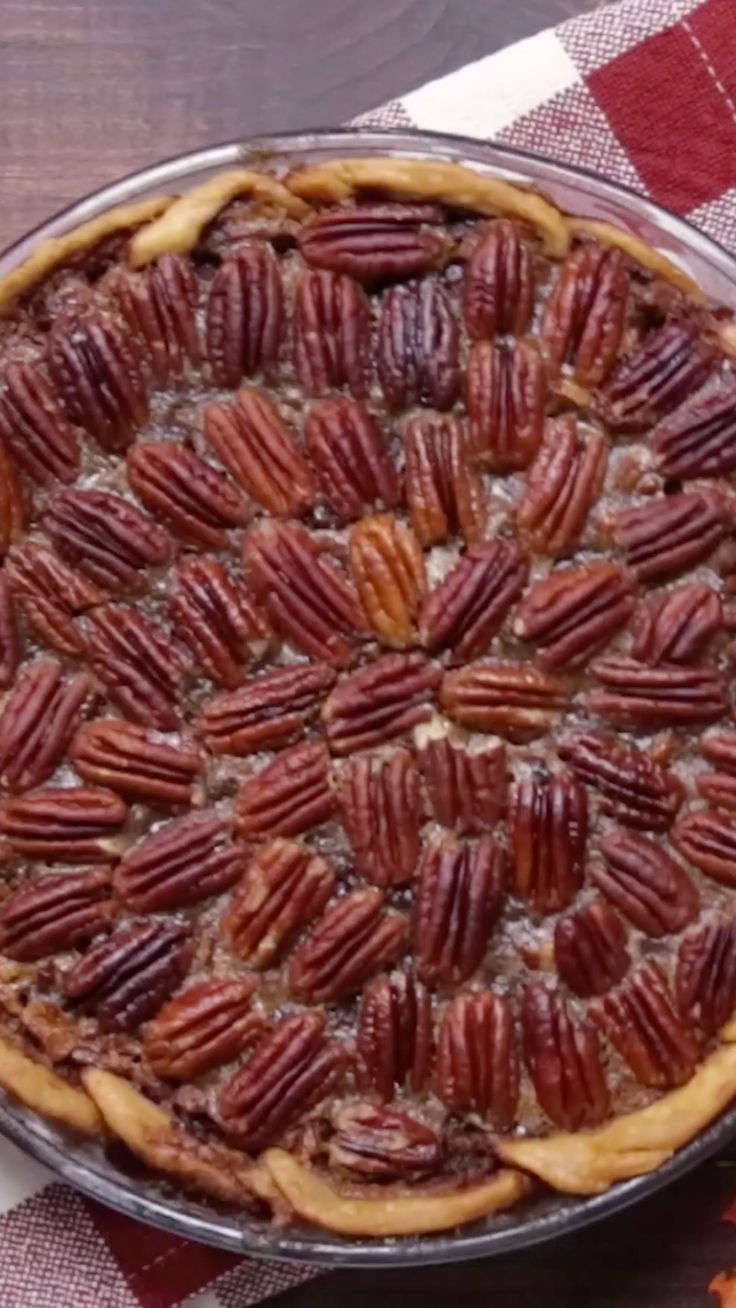 a pecan pie on a red and white checkered table cloth