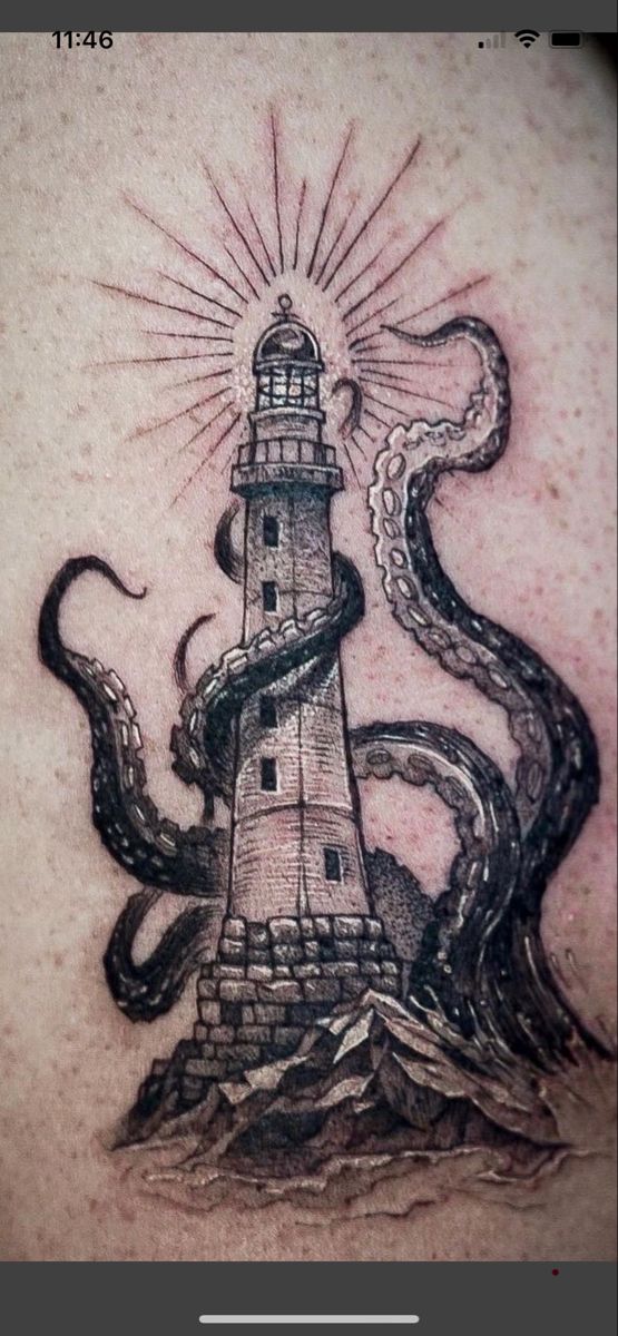 an octopus and lighthouse tattoo on the back