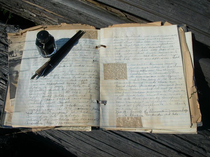 an open book with writing on it and a fountain pen sitting on top of it