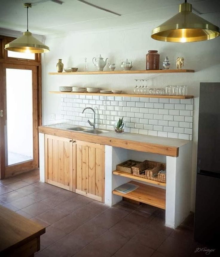 a kitchen with white tile and wooden cabinets