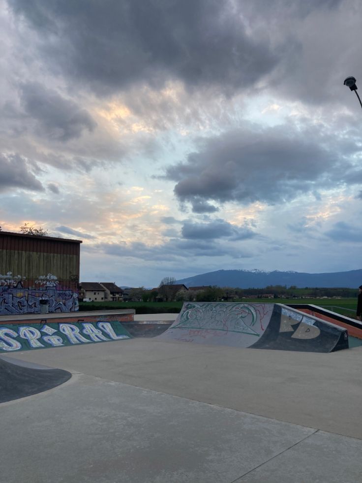 a man riding a skateboard up the side of a ramp at a skate park