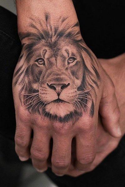 a man's hand with a lion tattoo on it