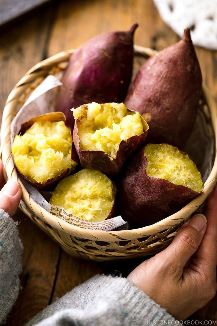 a basket filled with potatoes sitting on top of a wooden table