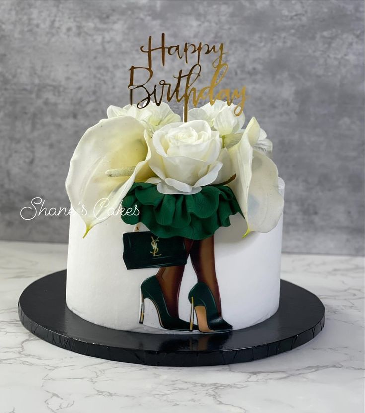 a birthday cake decorated with white roses and high heels