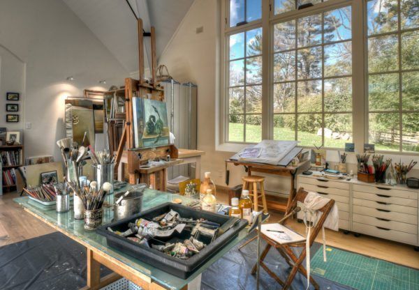 a living room filled with furniture and lots of windows