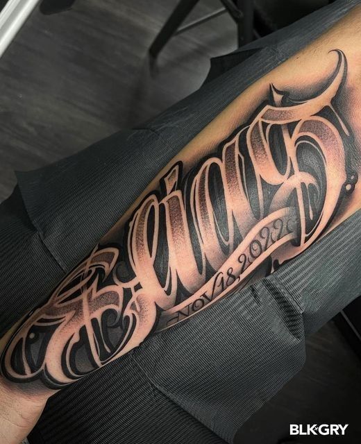 a man's arm with the word tattoo on it