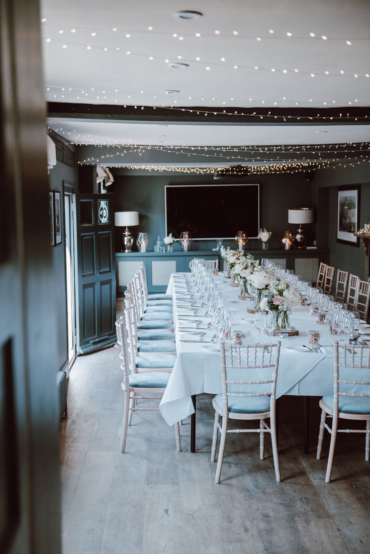 a long table set up with white linens