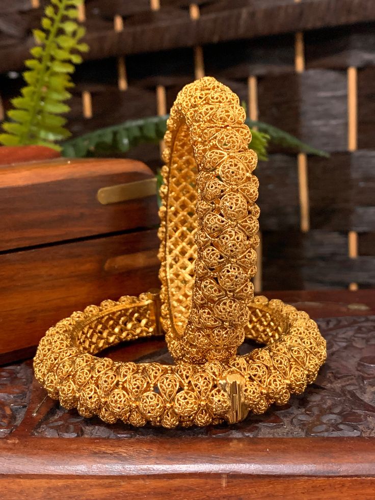 Gold plated temple style bangles shresthi. Both bangles are openable style. Rounded inside for total comfort. They run a little big on the size. Comes in a pair. 22k Gold Bangle For Puja And Festivals, Openable Round Bangle For Festivals, Openable Bangle For Festivals, 22k Gold Temple Jewelry Bangle With Cutdana, 22k Gold Bangle With Intricate Design For Puja, 22k Gold Bangle With Intricate Design For Diwali, Ceremonial Bangle With Intricate Design For Diwali, Traditional Openable Bangle For Diwali, Heavy Yellow Gold Temple Jewelry Bangle