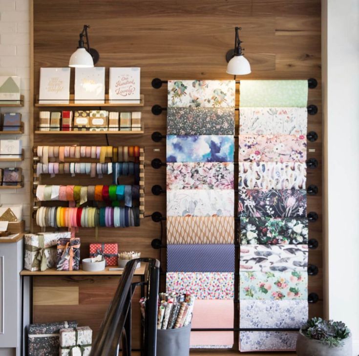 there are many different items on the shelves in this shop that is decorated with fabric