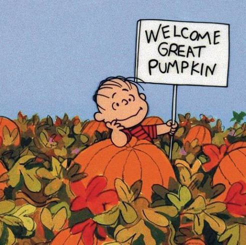 a cartoon character holding a sign that says, welcome great pumpkin in front of some pumpkins