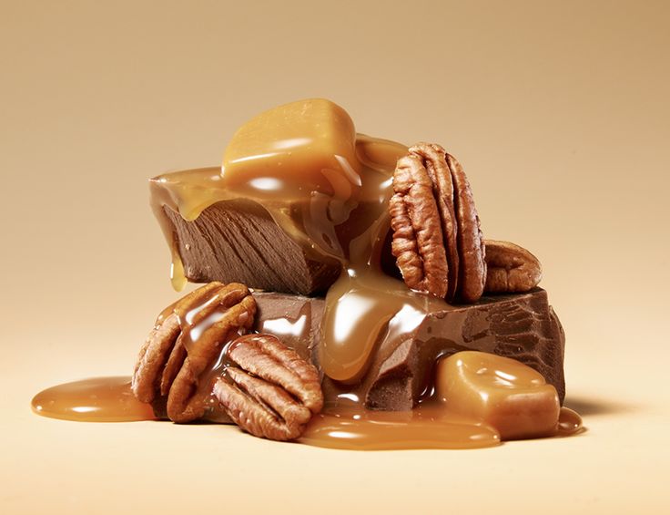 a pile of cookies and caramel on top of some kind of chocolate with peanut butter