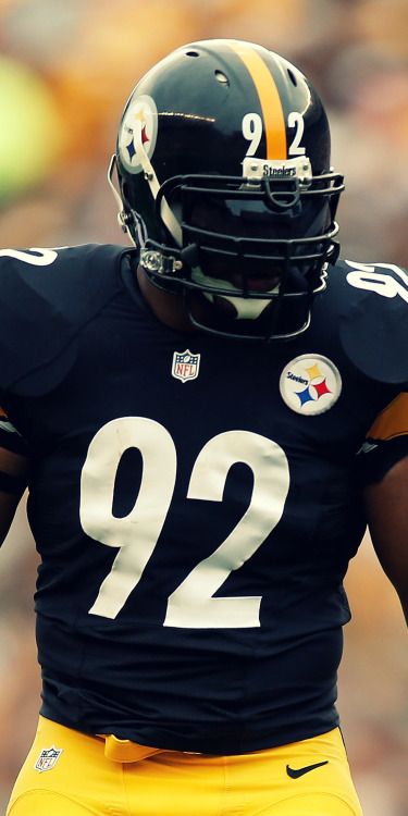 a football player wearing a black and yellow uniform