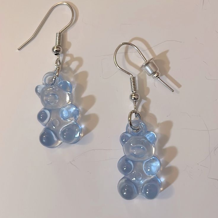 the earrings are made out of glass and have teddy bears on them, as well as silver earwires