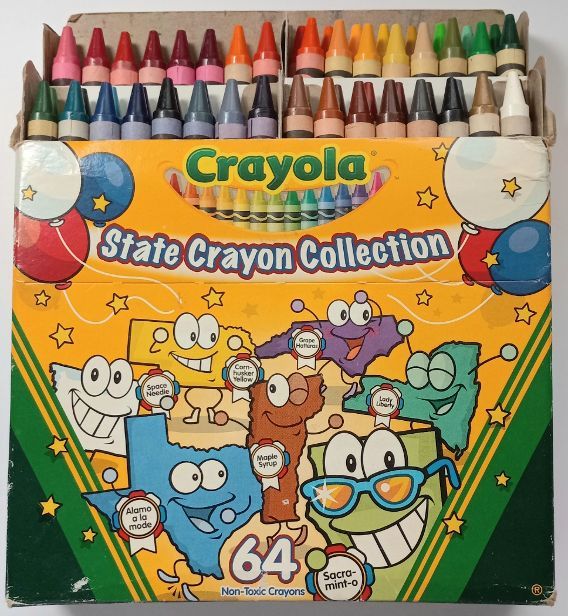 a box of crayon colored pencils sitting on top of a table