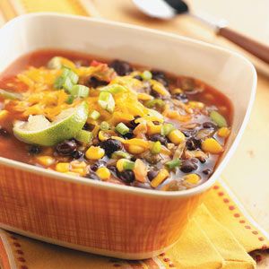 a bowl of chili and corn soup on a table