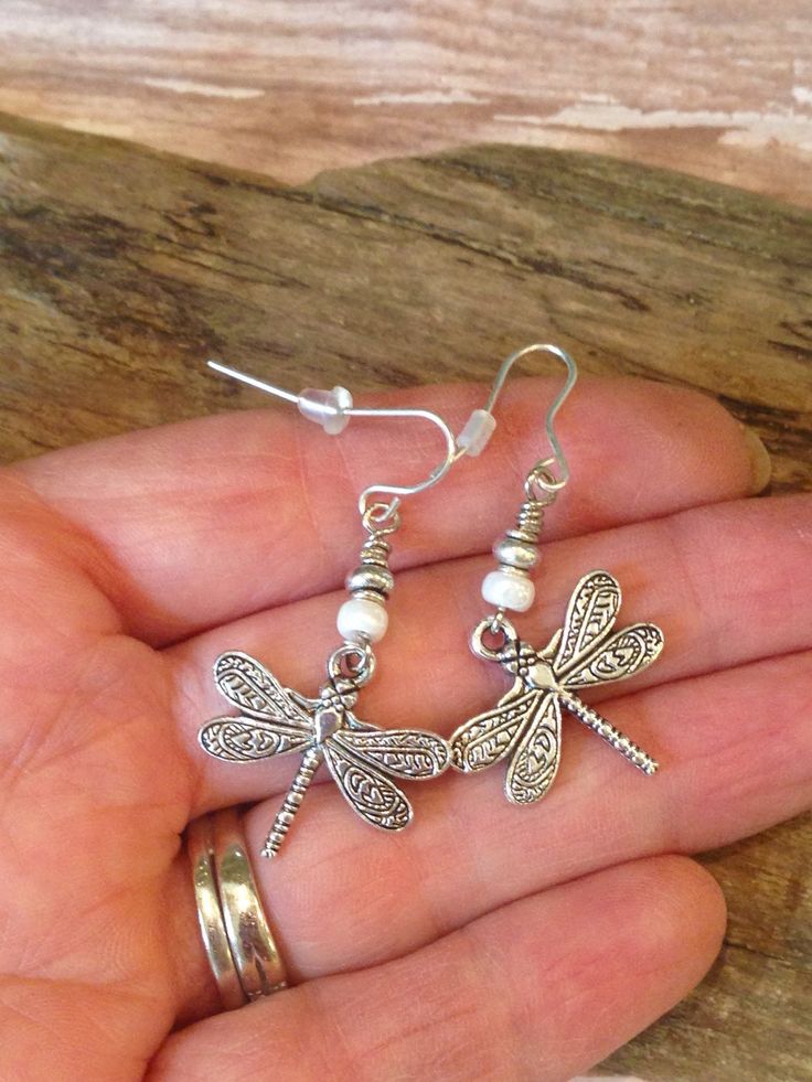 These gorgeous Boho Style Dragonfly Earrings are perfect for your summer wardrobe! So pretty with colors of cream and silver made with cream Czech seed beads, silver Tibetan beads and beautiful, detailed Silver Dragonfly charms! * I can switch out the cream beads for any color-just ask and I will be happy to do so.* The earring wires are lead free and will come with rubber backs. Beautiful gift idea which will come on a pretty gift box and organza bag! I have the complete jewelry set available f Summer Silver Butterfly Jewelry, Bohemian Butterfly Nickel-free Jewelry, Bohemian Adjustable Butterfly Earrings, Bohemian Silver Butterfly Earrings, Dragonfly Charm, Earring Wires, Dragonfly Earrings, Bohemian Earrings, Pretty Gift