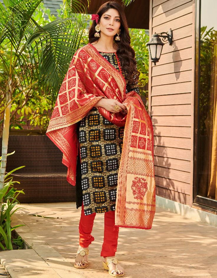 Black Bandhani Silk Blend Chudidar Salwar Suit Traditional Semi-stitched Churidar For Navratri, Navratri Bandhani Print Semi-stitched Churidar, Festive Semi-stitched Churidar With Bandhani Print, Unstitched Art Silk Churidar With Bandhani Print, Art Silk Churidar With Bandhani Print For Navratri, Semi-stitched Jamawar Sets With Motifs, Festive Bandhani Print Churidar For Festivals, Festive Churidar With Bandhani Print For Festivals, Traditional Semi-stitched Salwar Kameez With Zari Weaving