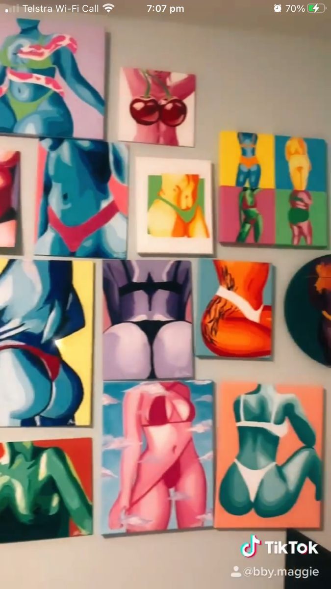 the wall is covered with many colorful paintings on it's sides, including bikinis and bras