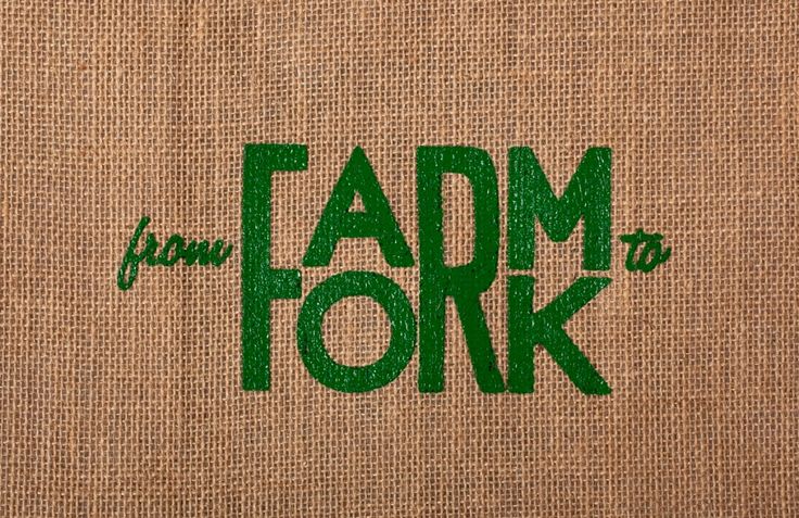 the words farm to fork are printed on burlocked canvas bags with green lettering