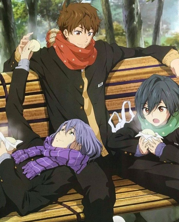 three people sitting on a bench in front of trees and one person is wearing a scarf