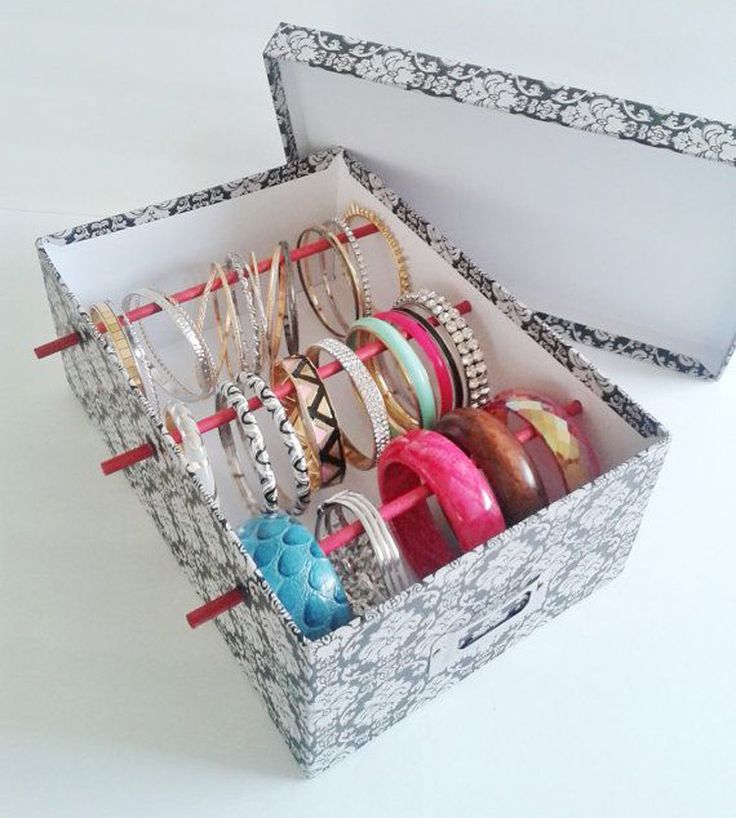 an open box filled with lots of different types of bracelets and ring boxes on top of each other