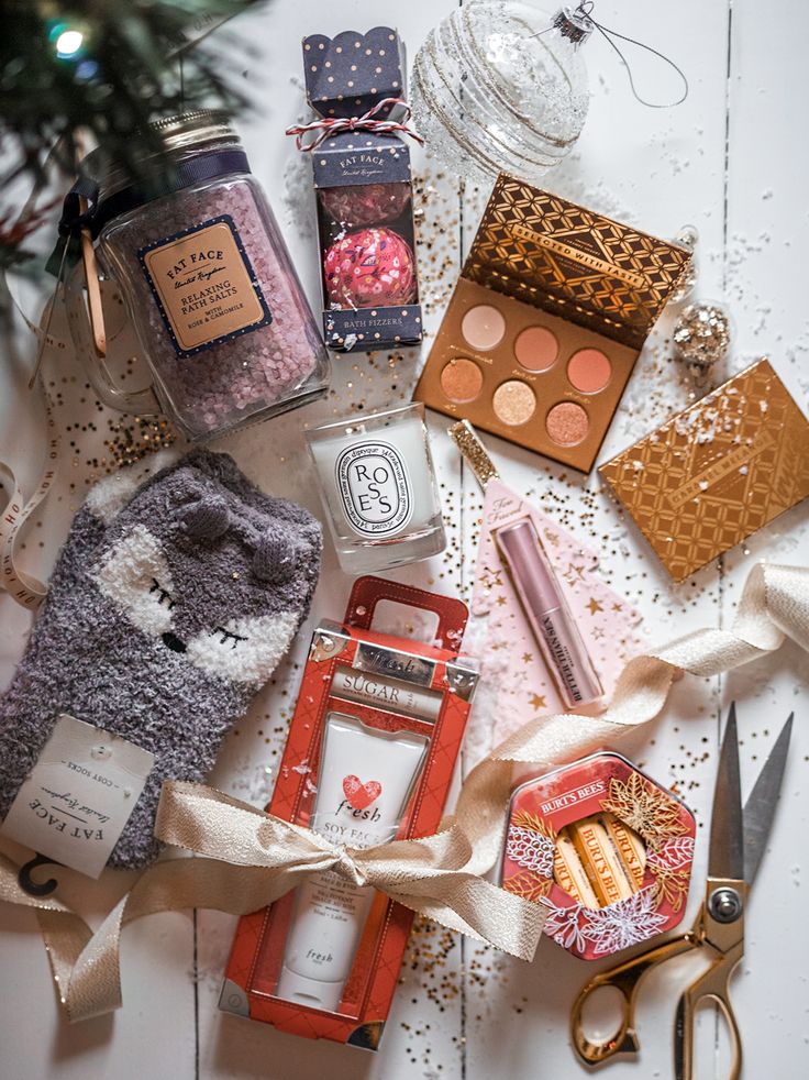 a table topped with lots of different items next to a christmas tree ornament