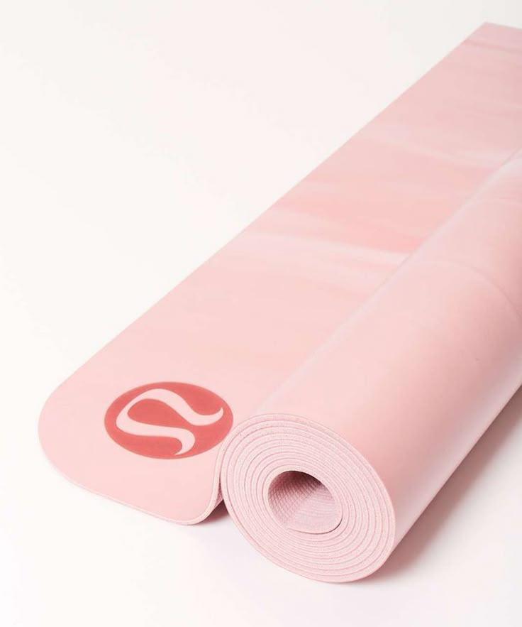 pink yoga mat rolled up on top of each other with the letter s on it