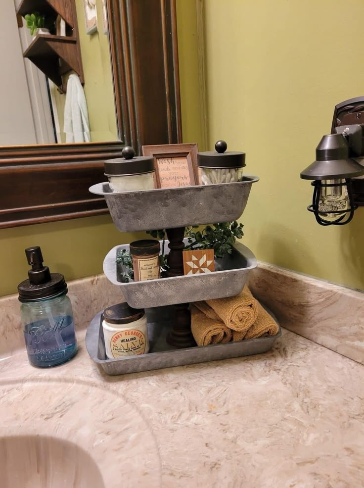 a bathroom sink with three tiered trays on it