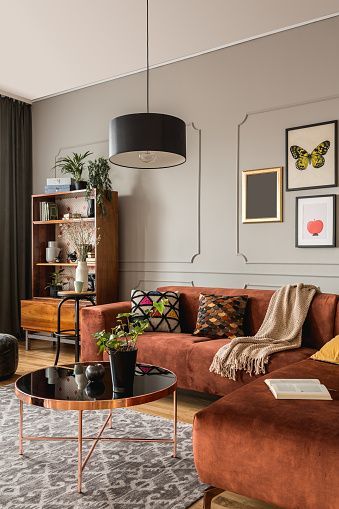 a living room filled with lots of furniture and pictures on the wall above it's coffee table