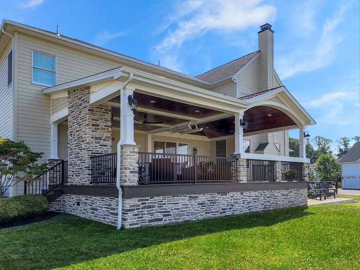 a large house with a covered porch in the front yard