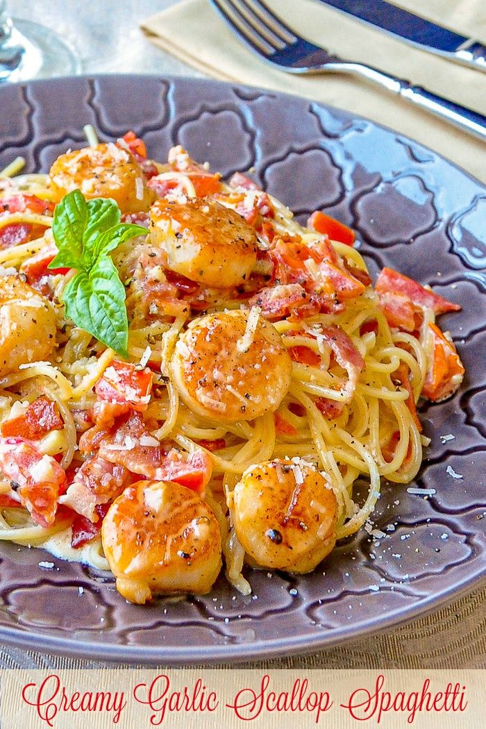 a blue plate topped with pasta and shrimp