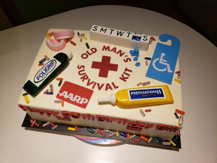 a cake that is on top of a table with various items around it, including toothpaste and mouthwash