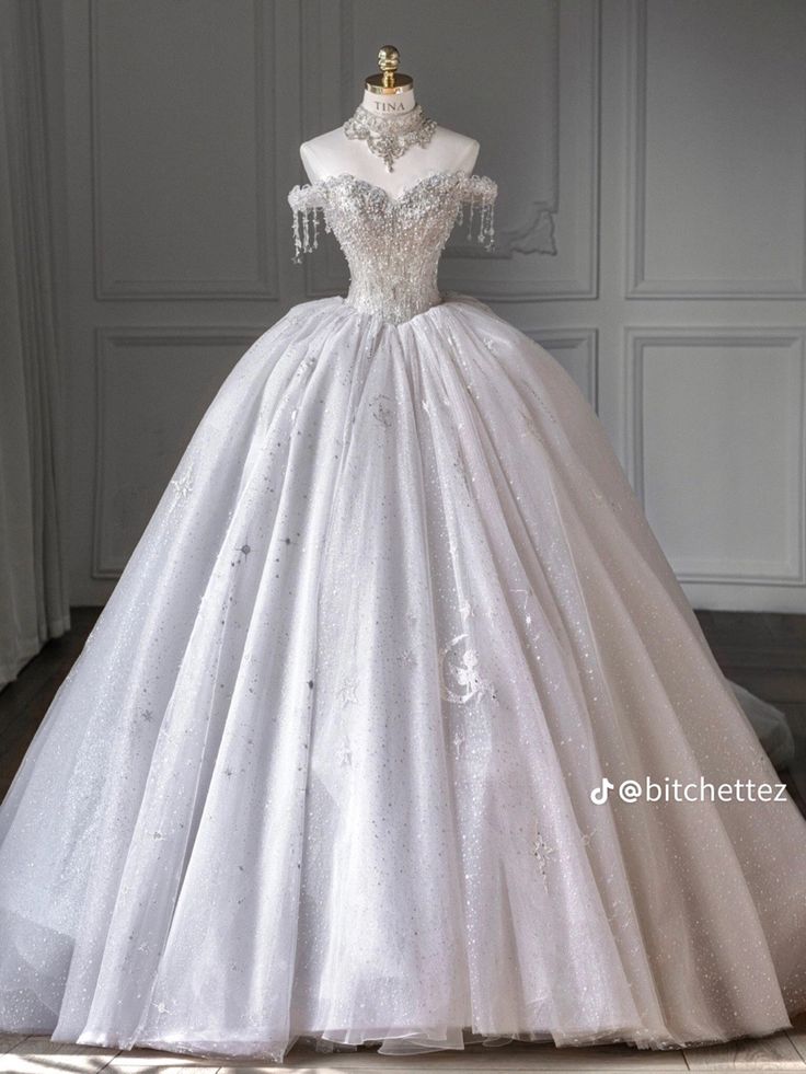 a white ball gown with beading and sequins on the bouncy