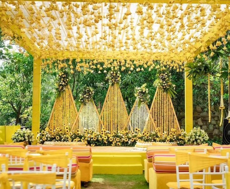 an outdoor wedding venue with yellow and white decor