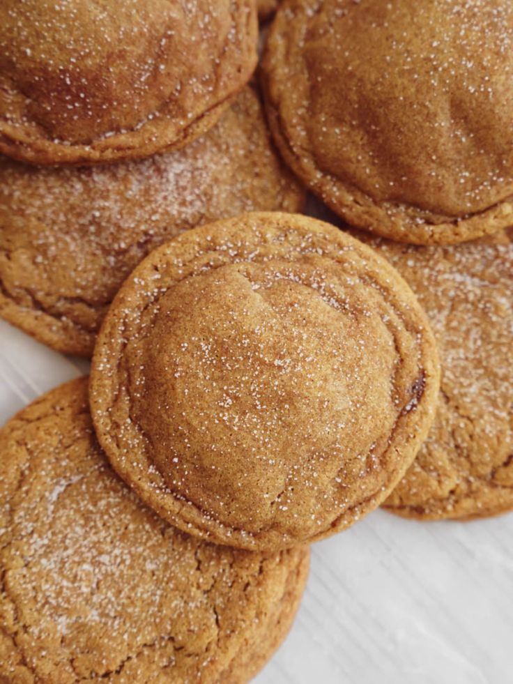 some cookies that are sitting on top of each other with powdered sugar all over them