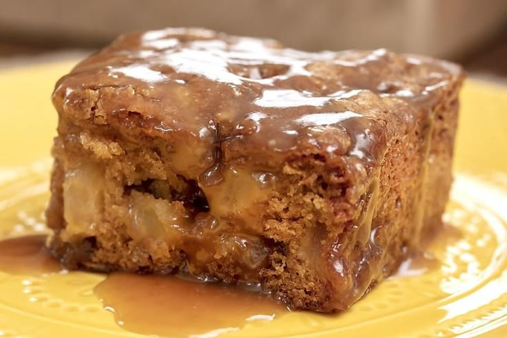 a close up of a piece of cake on a plate with caramel drizzle