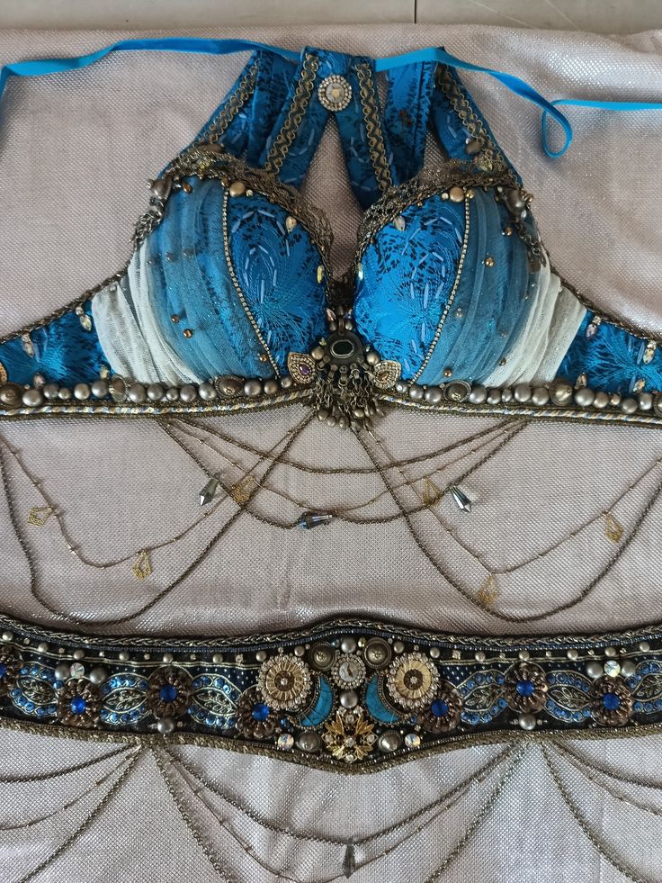 two blue bras are laying on top of each other