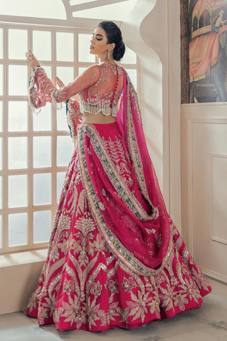 Embellished Shocking Pink Lehenga Choli for Bridal Wear comes in embellished work of zardozi, Mukesh, and Resham on every inch of this Shocking Pink lehenga choli. The fabric used for this lehenga choli is raw silk. Net embellished dupatta is paired with this lehenga choli.SKU: LN49 Lehnga Designs For Bridal, Pink Bridal Lehenga Brides, Pink Lehnga Outfit Wedding, Sabiya Sachi Lehenga, Hot Pink Bridal Lehenga Wedding, Heavy Lehenga Designs, Magenta Pink Bridal Lehenga, Pink Lengha Bridal, Shocking Pink Lehenga