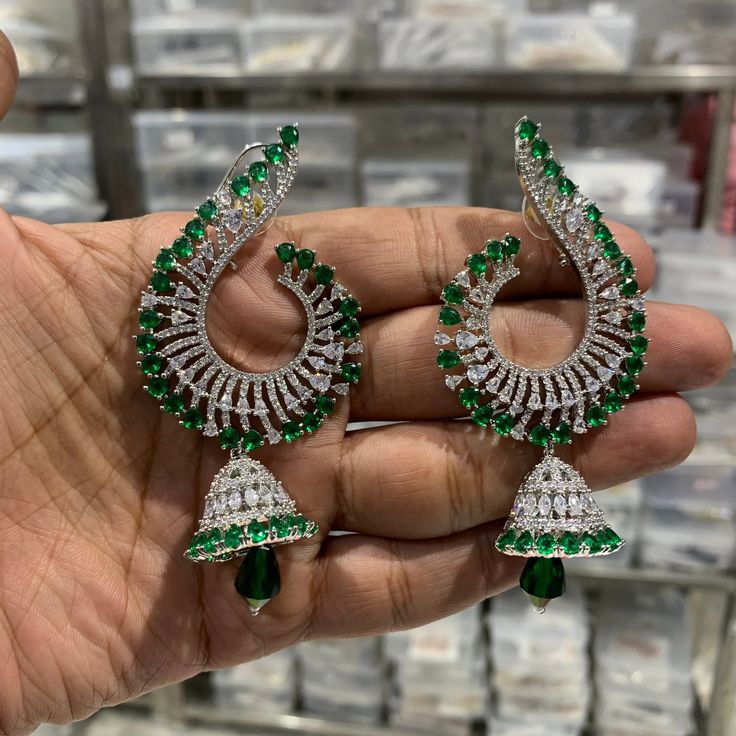 Bridal jhumka, Bridal earrings, Bollywood Earrings, Indian Jewelry, North Indian Earring Gorgeous Gold plated big jhumka Indian earrings with peacock shaped stud white American diamond stones and green stone and one big green bead hanging in the center. Looks Perfect for any traditional wear or Outfit. Traditional Green Tikka For Festive Occasions, Heavy Bollywood Dupatta For Diwali, Green Tikka With Latkans For Festivals, Green Stone Work Chandbalis For Celebration, Green Chandbali Tikka For Festive Occasions, Green Chandbali Tikka For Celebration, Green Chandbali Tikka For Festivals, Festive Green Chandbali Tikka, Bollywood Green Tikka For Festive Occasions