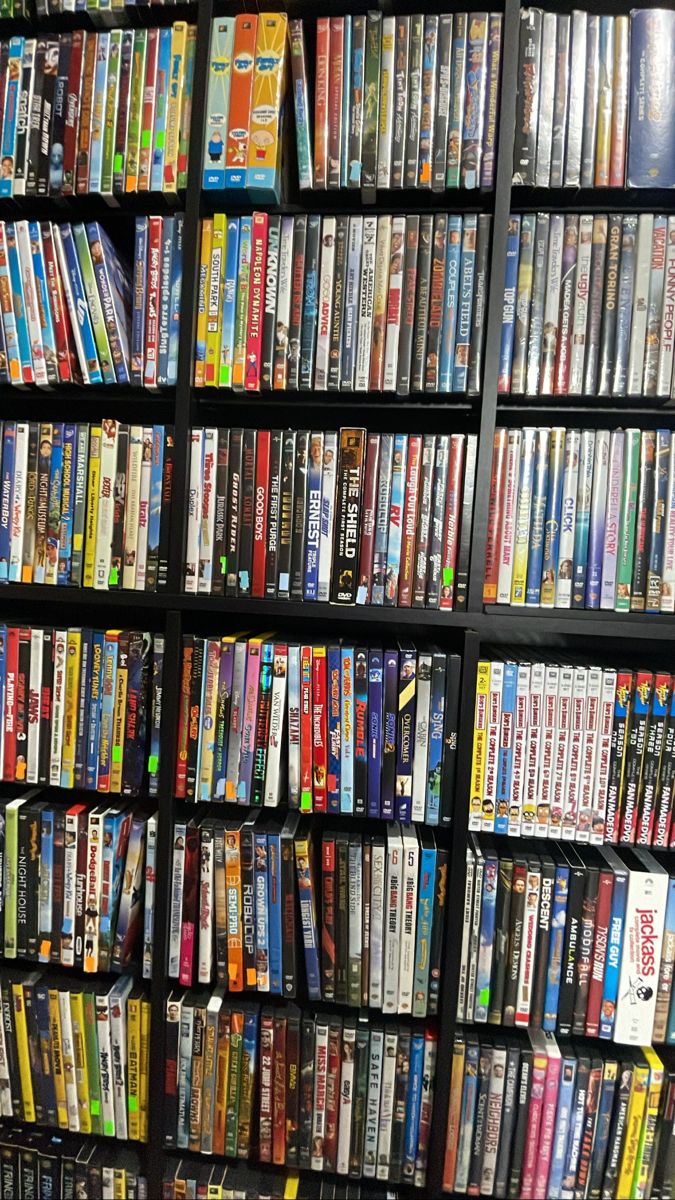 a large collection of dvd's are on display in a store or office building