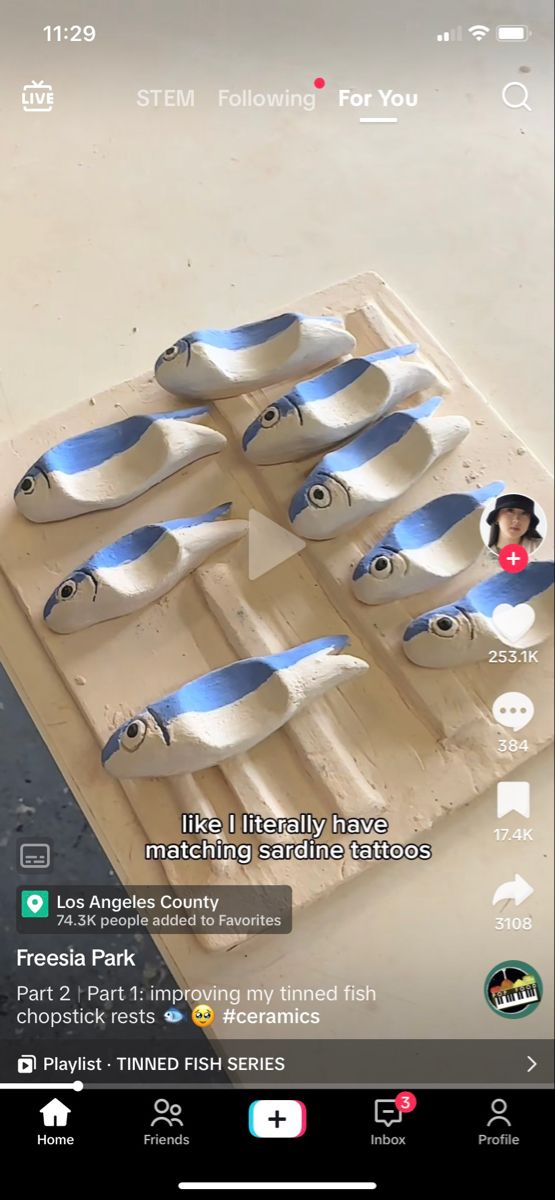 an image of some fish on a wooden board with blue and white stripes in the middle