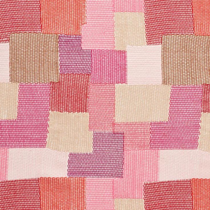 an orange, pink and white checkered pattern on fabric