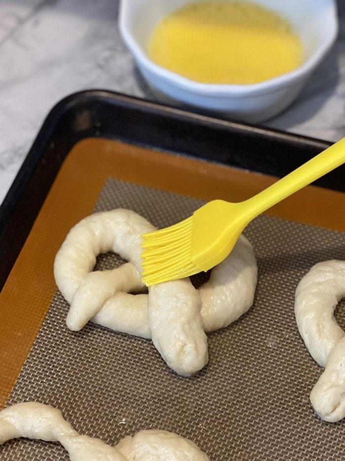 the doughnuts are being made with a yellow brush