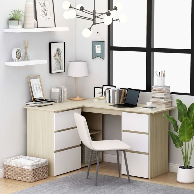 a desk with a chair, lamp and pictures on the wall