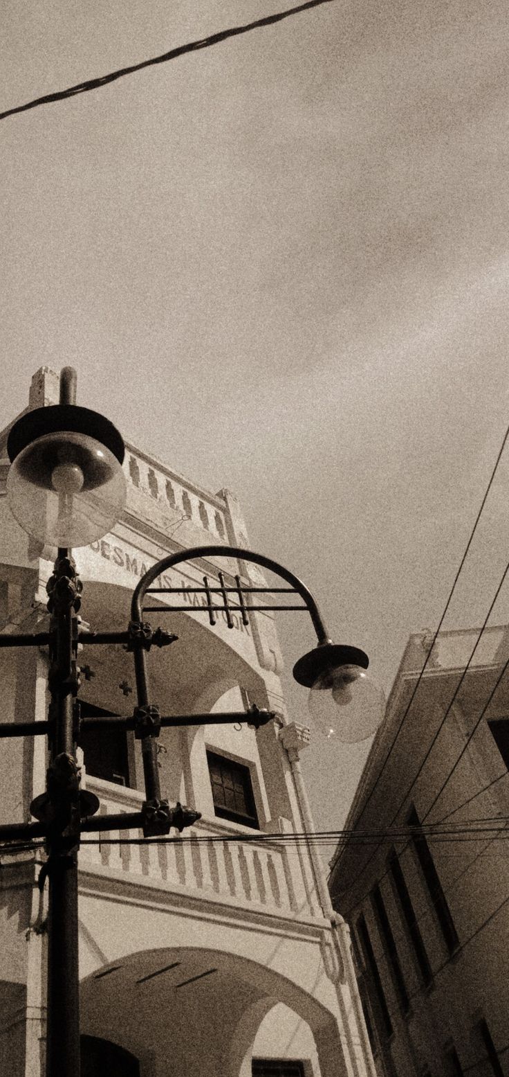 an old fashioned street light in front of a building