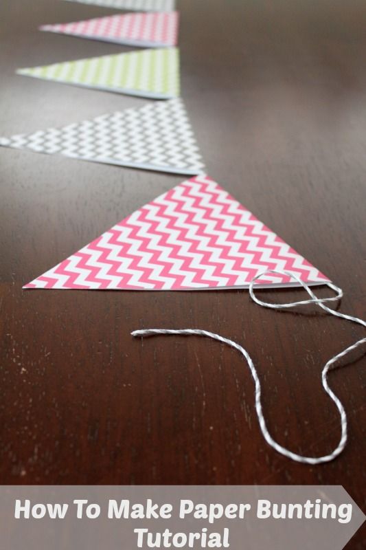 some paper triangles are sitting on a table with string in the middle and one is red, white and green