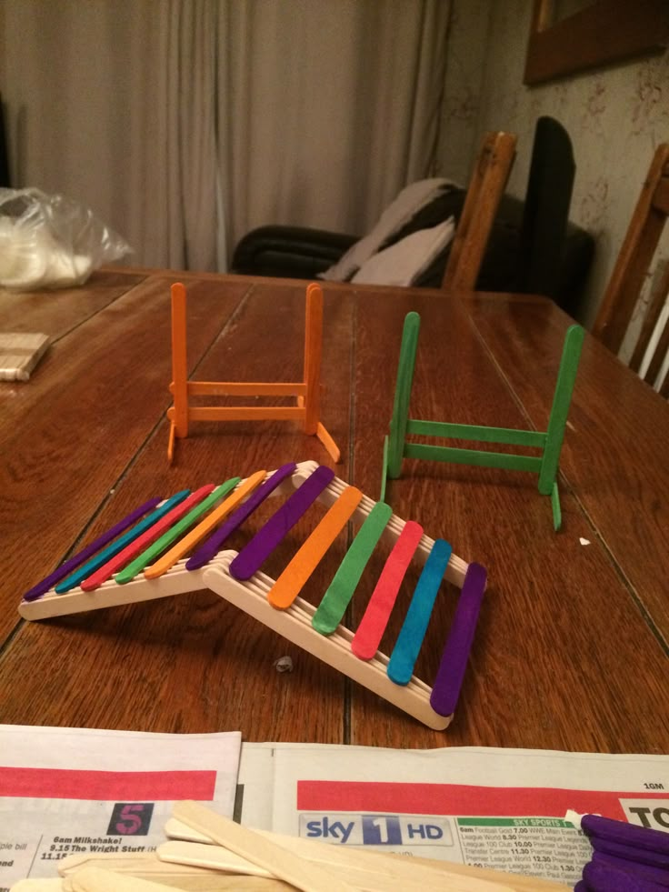 an assortment of colorful wooden toys sitting on top of a table next to each other