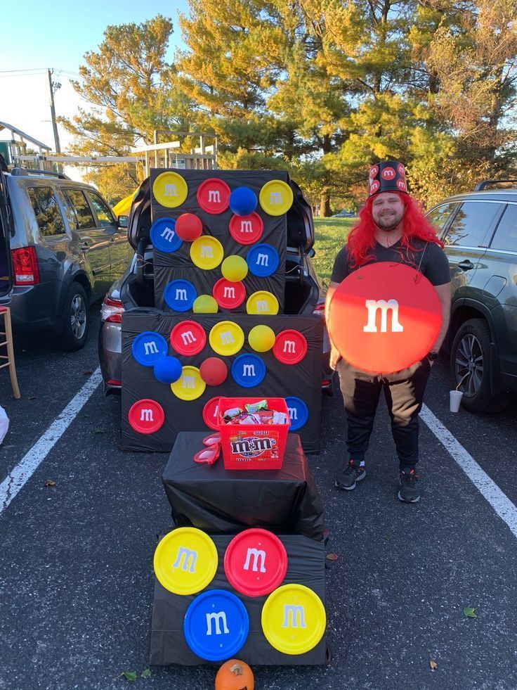 a man in costume holding up a frisbee next to an array of games