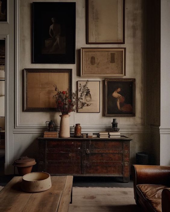 a living room filled with furniture and pictures on the wall