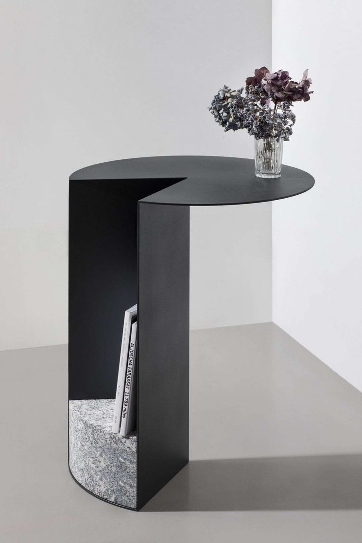 a vase with some flowers in it sitting on a table next to a book shelf